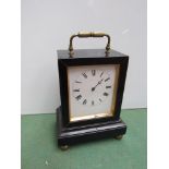 A 19th Century ebonised carriage timepiece with brass handle and bun feet,