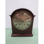 A mahogany domed top bracket clock with silvered Roman dial,