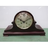 A mahogany Napoleon hat form mantel clock on stepped base, Arabic silvered dial with 8 day movement,