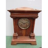 An early 20th Century oak mantel clock of architectural form with Arabic silvered dial,