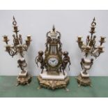 A decorative brass and marble clock with garniture of lyre form surmounted by hooved cherubs and