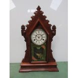 An American mahogany and carved "gingerbread" style mantel clock with Roman dial and 8 day movement,