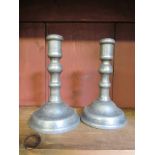 A pair of 18th Century pewter candlestick with pushers and domed bases, baluster stems, 14.