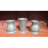 Two pewter baluster form half pint measures and a fluted beaker