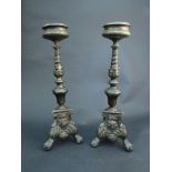 A pair of antique bronzed candlesticks with mask detail, 36.