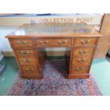 A Victorian mahogany twin pedestal desk with gilt tooled green leather top, brass swan neck handles,