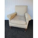 A Victorian armchair, the square back over cylindrical arms, turned supports,