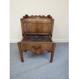 A George III mahogany night table with 3/4 gallery above a lift up door cupboard,