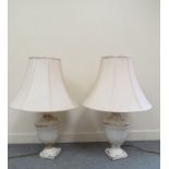 A large pair of crackle glazed pottery table lamps with cream shades,