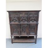 A 17th Century style Gothic cupboard on raised base with side doors and three front cupboard doors.