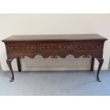 A late 20th Century reproduction oak sideboard in the Queen Anne style,