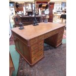 A late 19th Century oak twin pedestal desk with nine drawers,