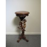 A 19th Century carved hardwood jardiniere stand with incorporated figure of boy climbing,