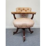A Victorian mahogany framed revolving desk chair (reupholstered)