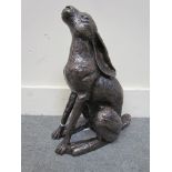 A cold cast resin bronze figure of a hare moon-gazing,