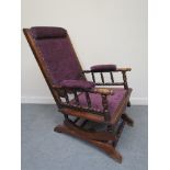 A circa 1900 American rocking chair with purple upholstery
