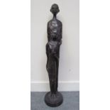 A cast bronze figure of African tribal people,