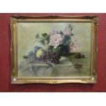 An oil on canvas of still-life flowers and grapes on textiles, gilt framed,