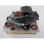 A vintage cast metal car themed money box