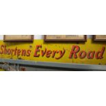 "Shortens Every Road" enamel sign