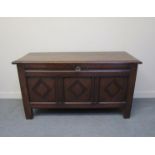 A 18th Century oak coffer with three panelled oak front with lozenge design,