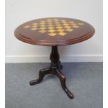 A 19th Century circular chequerboard inlaid table on carved fluted column to carved tripod base