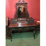 A late Victorian dressing table with shaped mirror back, blind fret detail, cabriole legs,