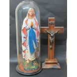 A painted figure of Mary under glass dome and religious crucifix