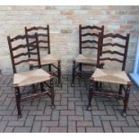 A set of four circa 1800 rush seated country wavy ladder back chairs made in cherry fruitwood