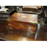 A 19th Century mahogany and brass bound writing box with fitted fold out interior with key and