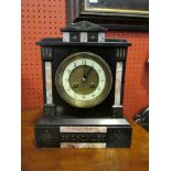 An early 20th Century black slate mantel clock (with key)