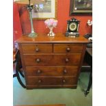 A 19th Century mahogany chest of two over three drawers with rounded corners, bun handles,