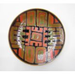 A Poole Studio plate with abstract design in black, green & orange. Blue back stamp. 27cm diameter.