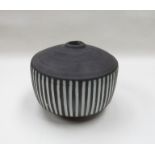 A Briglin pottery vase, blackened glaze with white filled vertical incised lines.