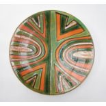 A Poole Studio plate, curved line detail in black, orange & green. Blue back stamp.