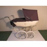 A silver cross dolls pram,