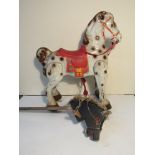 A Mobo Bronco painted metal horse and a carved wood hobby horse