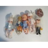 Five assorted plastic dolls in outfits