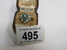 An 18ct gold diamond and emerald cluster ring,