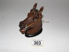 A cold painted spelter horse head match striker