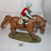A resin sculpture of a racehorse with jockey