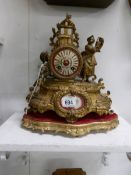 A French gilded mantel clock surmounted figure