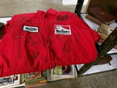 A pair of McLaren Pit stop overalls signed by Michael Schumaker, Lewis Hamilto, Niki Lauder,