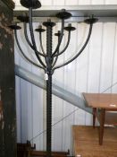 A floor standing wrought iron candelabra