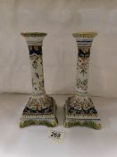 A pair of Italian Majolica hand painted candle stands
