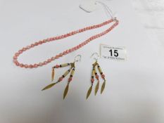 A coral bead necklace and earrings