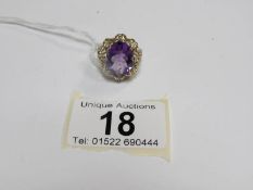 A superb quality amethyst set 9ct gold ring with small diamonds and heart mount,