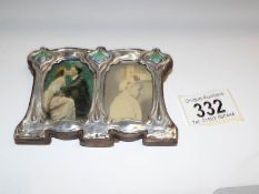 A small silver and enamel double photo frame