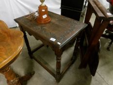 A carved oak occasional table