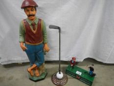 A golfing figure, a poker on golf ball stand and a golfing mechanical money bank